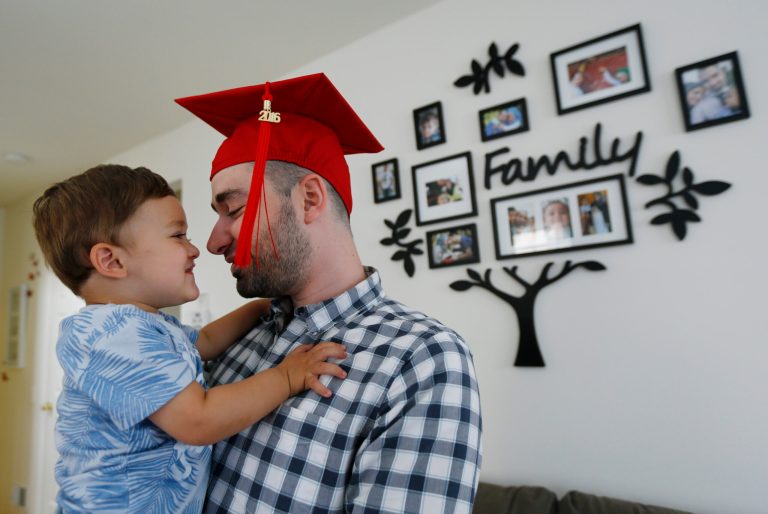 Mohamad Bassel Khair, right, kisses his 2-year-old son Sami Khair. Khair, of Damascus, Syria, is graduating from Montclair State University with a master's degree in nutrition and food science. Before applying to the New Jersey school in 2013, he and his wife had fled Syria to Egypt, where they couldn't legally work. More colleges in the U.S. are offering scholarships to Syrian refugees. (AP Photo/Julio Cortez)