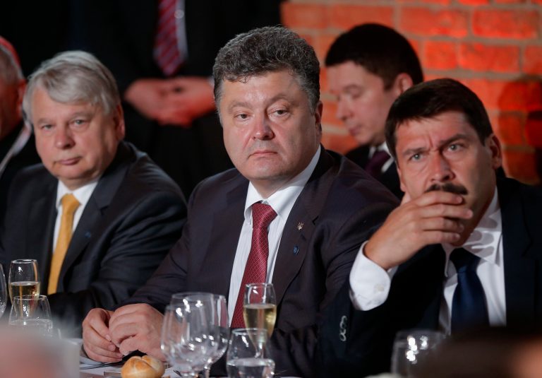Ukraine president-elect Petro Poroshenkois, center, seated with Belgian Foreign Minister Didier Reynders, left, and Hungarian President Janos Ader, attend a dinner with President Barack Obama, hosted by Polish President Bronislaw Komorowski at the Royal Castle in Warsaw, Poland, Tuesday, June 3, 2014. (AP Photo/Charles Dharapak)