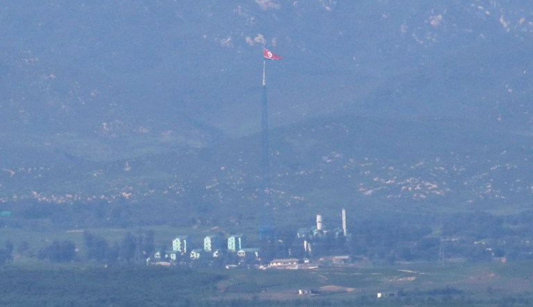 A giant North Korean flag, center, atop a 160-meter (525-foot) tower in North Korea, flutters in the wind, seen from Paju, South Korea, Tuesday, Aug. 29, 2017. In a first, North Korea on Tuesday fired a midrange ballistic missile designed to carry a nuclear payload that flew over Japan and splashed into the northern Pacific Ocean, officials said. The aggressive missile launch -- likely the longest ever from the North -- over the territory of a close U.S. ally sends a clear message of defiance as Washington and Seoul conduct war games nearby. (AP Photo/Lee Jin-man)