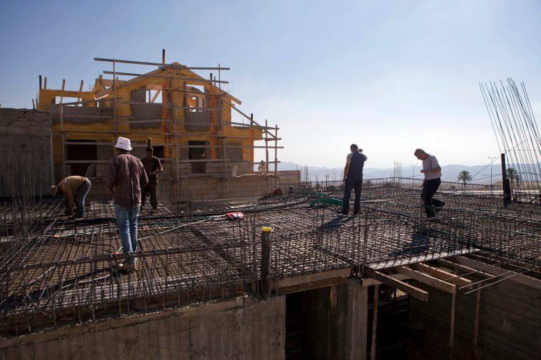Palestinians laborers work at a construction site in the Jewish West Bank settlement of Maale Adumim, near Jerusalem. Tuesday, Sept. 16, 2014. Israel's settler population in the West Bank increased by 2 percent in the first half of the year, an advocacy group announced Tuesday, signaling robust growth in the settlements even while Israel was conducting peace talks with the Palestinians. The new figures drew criticism from the Palestinians, who seek the West Bank as part of a future state. The Palestinians and most of the international community consider Israeli construction there to be illegal or illegitimate. (AP Photo/Dan Balilty)