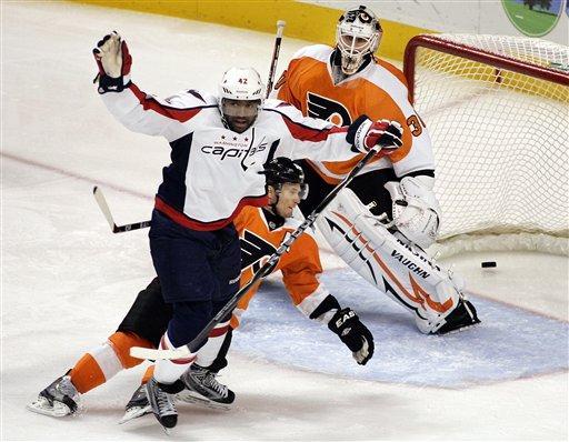 Washington Capitals' Joel Ward reacts after scoring a goal as Philadelphia Flyers' Kimmo Timonen and goalie Ilya Bryzgalov watch during the third period of an NHL hockey game Thursday, Oct. 20, 2011, in Philadelphia. The Capitals won 5-2. (AP Photo/Tom Mihalek)