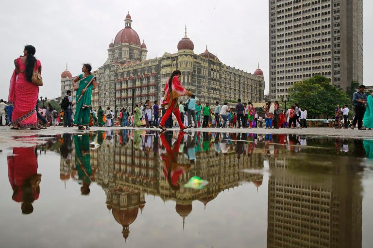 People walk outside the Taj Mahal hotel, which was one of the targets of the 2008 terror attacks by a small group of Pakistani militants in Mumbai, India, Thursday, Sept. 4, 2014. At least three Indian states with large Muslim populations have been put on alert in the wake of a video release where the leader of Al-Qaida says the terrorist group has expanded into India.(AP Photo/Rafiq Maqbool)