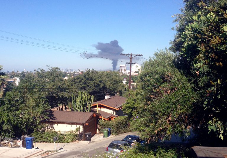 A large plume of smoke is shown Sunday July 13, 2014 in Los Angeles. Authorities say a fire has torn through a chrome-plating facility in  the Hollywood section of Los Angeles, sending this giant plume of black smoke into the air. The fire broke out shortly before 9 a.m. Sunday at an industrial building. A spokesman said more than 100 firefighters were dispatched to the blaze. (AP Photo/Alicia Chang)