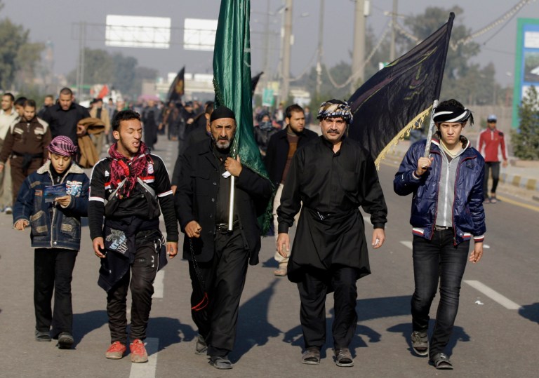   Shiite pilgrims march to Karbala for the Arbaeen celebration in Baghdad, Iraq, Monday, Dec. 31, 2012. Each year, hundreds of thousands converge on the southern city of Karbala to mark the end of the forty day mourning period following the anniversary of the 7th century death of the Prophet Muhammad's grandson, Imam Hussein. (AP Photo/ Karim Kadim)  