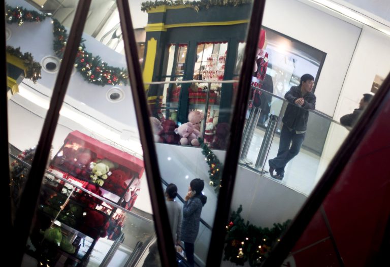   Chinese shoppers and Christmas decorations are reflected in mirrors inside a shopping mall in Beijing Monday, Dec. 10, 2012. China's trade weakened sharply in November, adding to challenges for the world's second-largest economy as a gradual recovery takes shape. Export growth plunged to 2.9 percent over a year earlier from the previous month's 11.6 percent, customs data showed Monday. Imports were flat, down from October's 2.4 percent growth. (AP Photo/Andy Wong)  