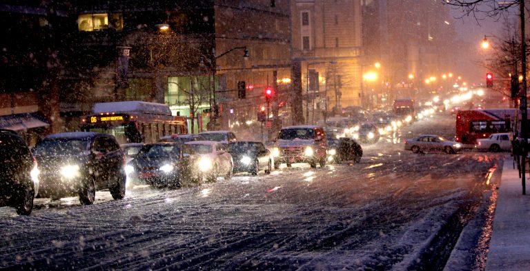 Vehicles drive in the snow in downtown D.C. (AP file photo)