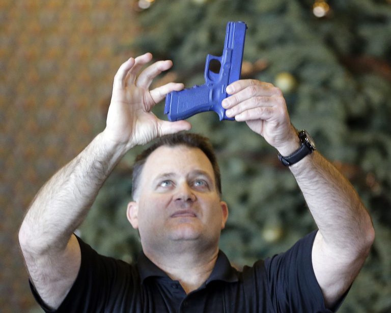 Clark Aposhian, president of the Utah Shooting Sport Council, uses a plastic gun during concealed-weapons training for 200 Utah teachers in December  2012, in West Valley City, Utah. (AP Photo/Rick Bowmer)