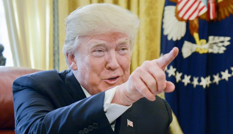 President Trump signed the GOP's $1.5 trillion tax cut bill on Dec. 22. The new law lets firms bring overseas earnings back to the U.S. without a penalty once they pay a one-time levy and reduces the top tax rate to 21 percent. (Mike Theiler/Pool via Bloomberg)