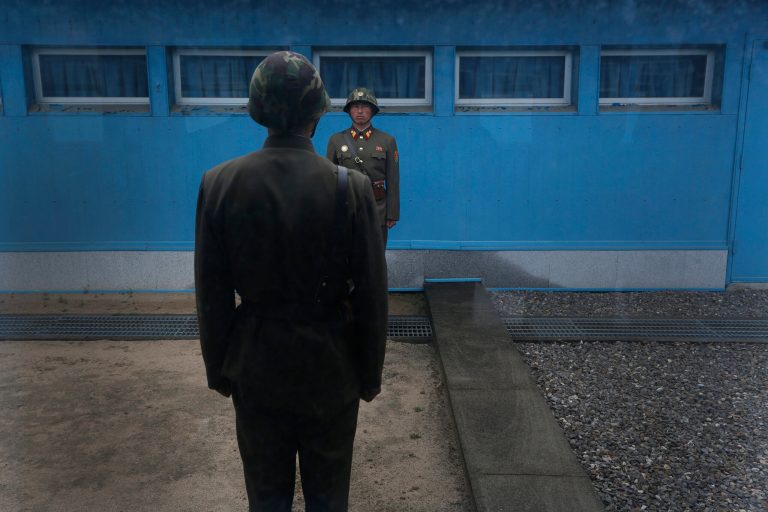 North Korean soldiers stand guard on the demarcation line of the Demilitarized Zone that separates the two halves of the Korean peninsula at Panmunjom, North Korea. (AP Photo/Vincent Yu)