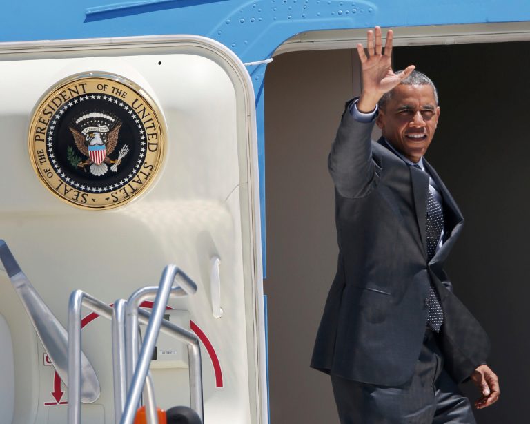 President Obama waves as he boards Air Force One at Denver International Airport on Wednesday en route to Dallas. (AP Photo/David Zalubowski)