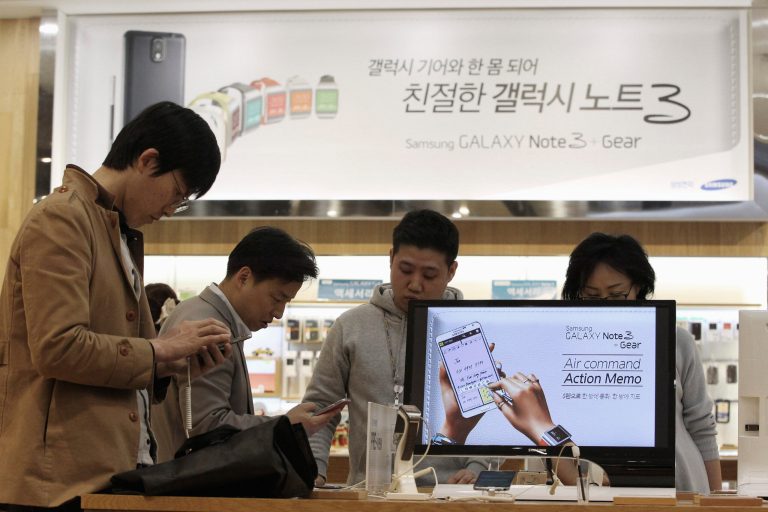 Visitors try out Samsung Electronics Co.'s Galaxy Note 3 at its showroom in Seoul, South Korea, Tuesday, April 1, 2014. Declining smartphone prices hit profit at Samsung for a second straight quarter. The consumer technology heavyweight said Tuesday that it expects operating income of about 8.4 trillion won ($8 billion) for the January-March quarter, down 4 percent from a year earlier. (AP Photo/Ahn Young-joon)
