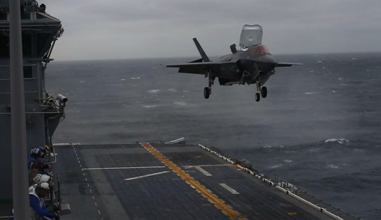 In a video released by the Marine Corps, a detachment of planes with Marine Fighter Attack Squadron 121 can be seen flying over the USS Wasp before stopping at a hover and landing vertically on the amphibious assault ship's flight deck. (Screenshot)