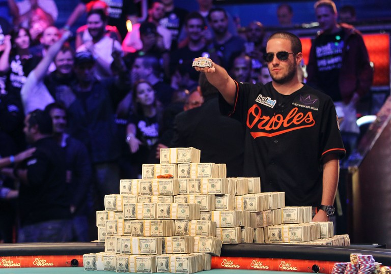 Greg Merson holds up his new bracelet after winning the World Series of Poker No-Limit Hold'em Main Event. (AP photo)