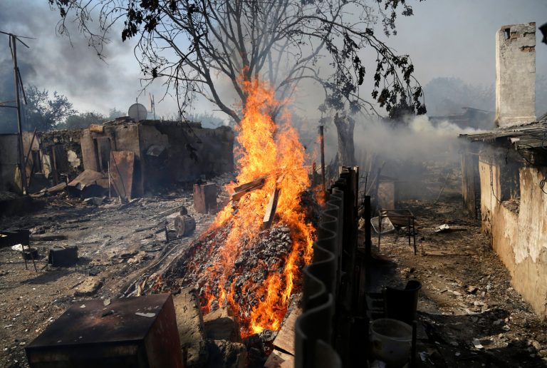 Homes burn after being hit by a shell in Donetsk, eastern Ukraine, Sunday, Sept. 7, 2014. Strong explosions were heard early Sunday on the outskirts of the main rebel-held city in eastern Ukraine near the airport, raising new fears that a cease-fire signed two days ago is on the verge of collapse. Blasts powerful enough to be heard in downtown Donetsk came from the area near the airport, which has been under the control of government troops since May and has come under unremitting attacks from pro-Russia separatist rebels since then. (AP Photo/Sergei Grits)