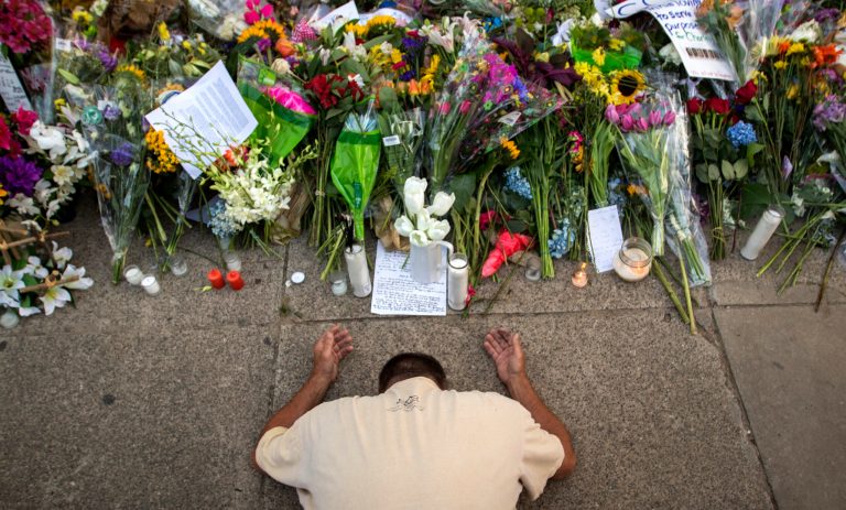Raymond Smith of Charleston kneels in prayer the front of the Emanuel AME Church before a worship service, Sunday, June 21, 2015, in Charleston, S.C. (AP Photo/Stephen B. Morton)