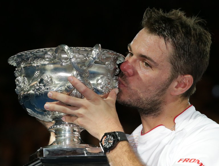 Stanislas Wawrinka of Switzerland kisses the trophy after defeating Rafael Nadal of Spainduring the men's singles final at the Australian Open tennis championship in Melbourne, Australia, Sunday, Jan. 26, 2014.(AP Photo/Aaron Favila)