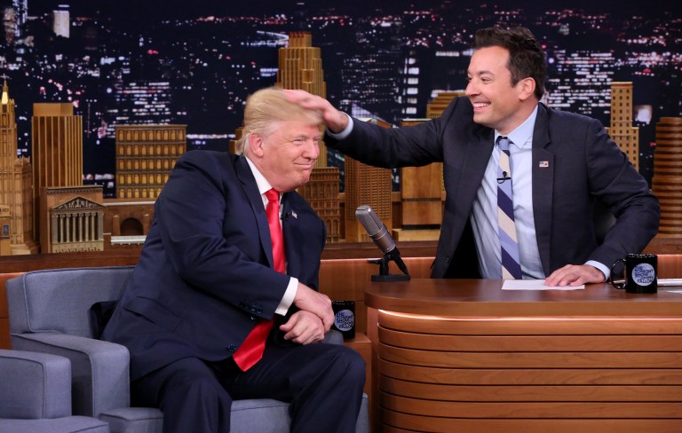 In this image released by NBC, Republican presidential candidate Donald Trump appears with host Jimmy Fallon during a taping of 