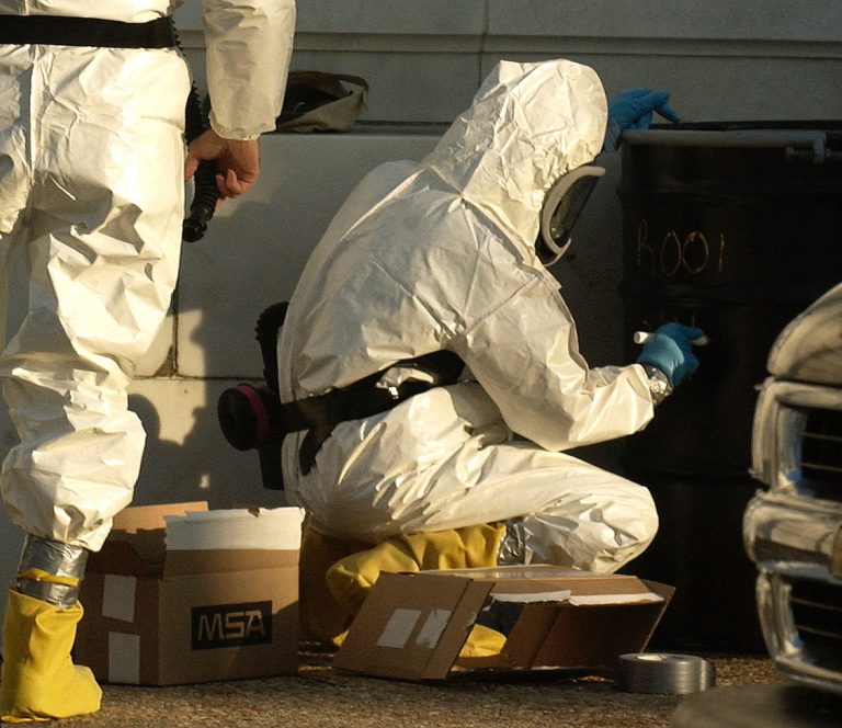 WASHINGTON - FEBRUARY 4:  Hazardous materials technicians put on protective gear and mark a 55-gallon drum as they prepare to enter the Russell Senate Office building on Capitol Hill February 4, 2004 in Washington, D.C. All three Senate office buildings are closed due to Ricin-contaminated mail found in the Dirksen Senate building February 2. Ricin is a toxin derived from the castor bean, and can be deadly. Early symptoms include fever, stomach ache and vomiting. Multiple organ failure resulting in death can occur within 36 to 72 hours. There is no antidote.  (Photo by Mannie Garcia/Getty Images)