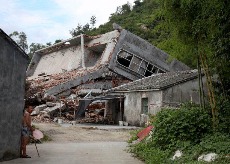 In this photo taken July 16, 2014, a man stands near the razed remains of a Catholic church in a village in Pingyang county of Wenzhou in eastern China's Zhejiang province. Across Zhejiang province, which hugs Chinaâs rocky southeastern coast, authorities have toppled - or threatened to topple - crosses at more than 130 churches. (AP Photo/Didi Tang)
