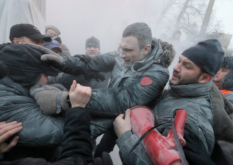 FILE -  In this Sunday, Jan. 19, 2014. file photo opposition leader and former WBC heavyweight boxing champion Vitali Klitschko, center, is attacked and sprayed with a fire extinguisher as he tries to stop the clashes between police and protesters in central Kiev, Ukraine. After two months of anti-government protests, modern Ukraine has never been so bitterly polarized. To be sure, Ukraine has long been divided. Russia and Europe have vied for dominance for centuries, causing deep cultural differences between the mostly Ukrainian-speaking western and central regions on the one hand, and the Russian-speaking east and south on the other. But as the crisis has deepened, each side has grown stronger in its convictions, and those who stood in the middle have been forced to choose sides.  (AP Photo/Efrem Lukatsky, file)