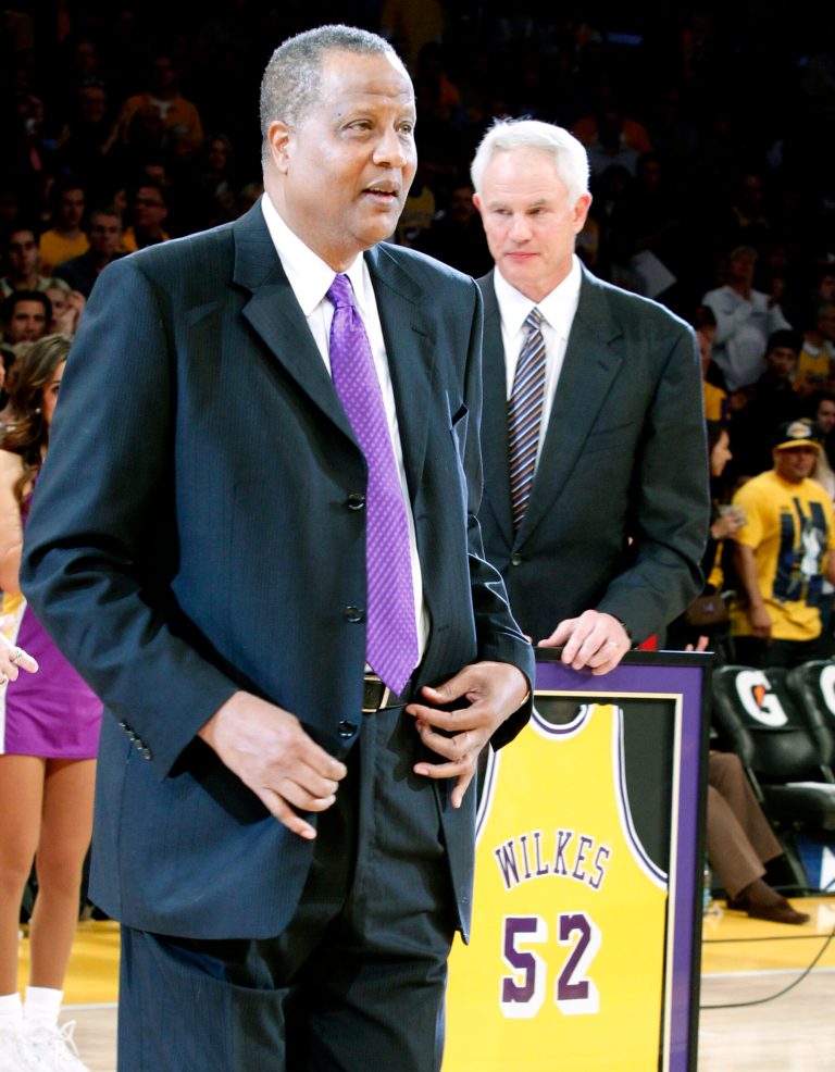   Los Angeles Lakers general manager Mitch Kupchak, right, holds the No. 52 jersey of former Laker Jamaal Wilkes during a jersey retirement ceremony at halftime of an NBA basketball game between the Lakers and the Portland Trail Blazers, Friday, Dec. 28, 2012, in Los Angeles. (AP Photo/Alex Gallardo)  