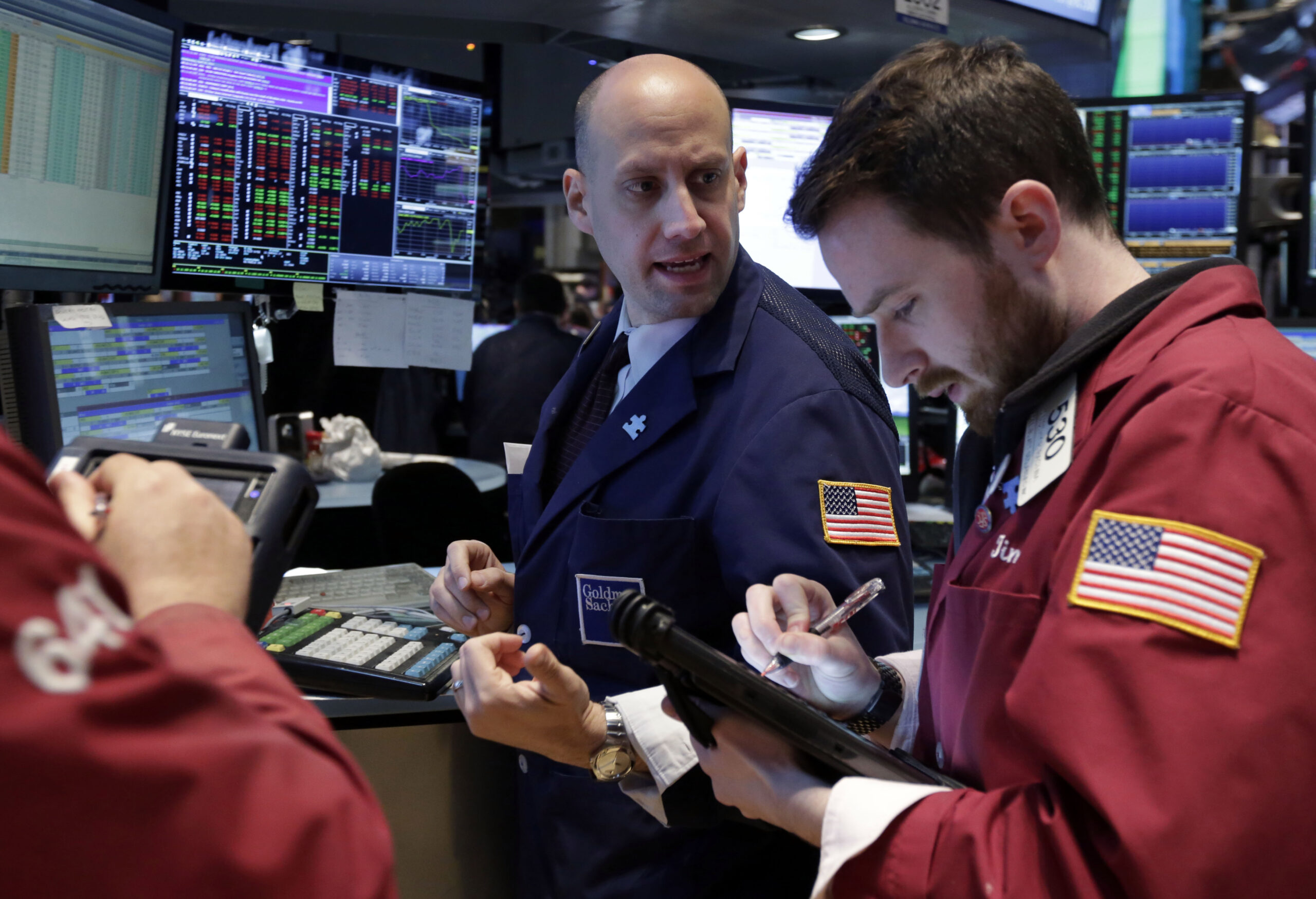 Dow closes at a record high, erases loss for year