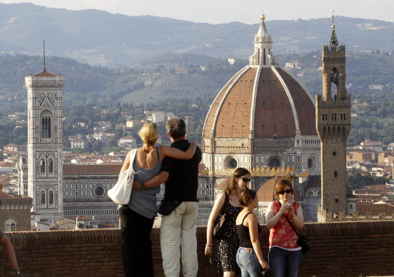 In this photo taken on July 8, 2013 a couple looks at the Florence Santa Maria del Fiore Basilica, with Giotto's bell tower, left, Brunelleschi's dome, from Forte Belvedere, Italy. Kim Kardashian and Kanye West will get married at Florence's imposing 16th century Belvedere Fort on May 24, a spokeswoman at the Florence mayor's office said Friday, May 16, 2014. The couple rented the fort, located next to Florence's famed Boboli Gardens, for 300,000 euros ($410,000). Di Lupo said a Protestant minister will preside, spokeswoman Elisa Di Lupo said. The 36-year-old rapper proposed to the reality star on her 33rd birthday in October 2013 renting out San Francisco's AT&T Park for the occasion. There has been no explicit confirmation from either Kardashian or West. In an email Thursday to The Associated Press, Kardashian's representative Ina Treciokas said she wasn't able to comment on reports about the nuptials. (AP Photo/Francesco Bellini)