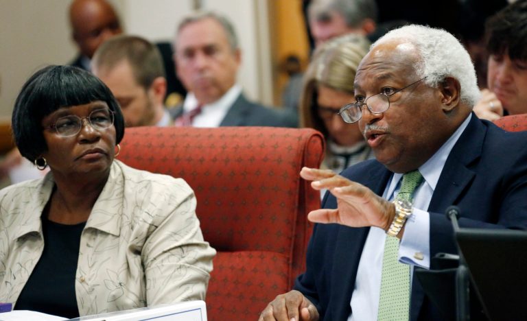 Josie McClorine, president of the Claiborne County School Board, left, listens as the school district's attorney, Everett Sanders speaks to the specifics of criteria used by the Commission on School Accreditation to evaluate their schools in Jackson, Miss., on Thursday. (AP/Rogelio V. Solis)
