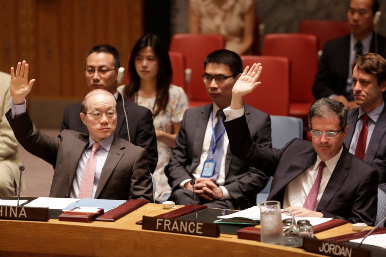 China's United Nations Ambassador Liu Jieyi, left, and French Ambassador Francois Delattre vote in favor of a Security Council resolution approving Iran's nuclear deal at United Nations headquarters, Monday, June 29, 2015. (AP Photo/Mark Lennihan)