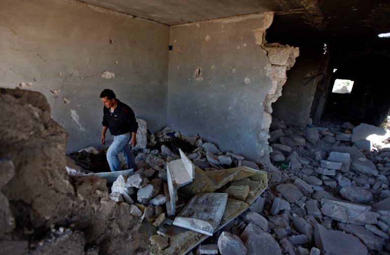   A Syrian man walks through the rubble of a destroyed military outpost the Free Syrian Army attacked in May, near Idlib, Syria, Thursday, June 14, 2012. (AP Photo)  