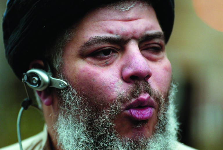 FILE - In this Jan. 23, 2004 file photo, self-styled cleric Abu Hamza al-Masri leads his followers in prayer in a street outside Finsbury Park Mosque, on the first anniversary of its closure by anti-terrorism police, London. Britain is set to extradite its most recognizable extremist, Abu Hamza al-Masri, to the United States, sending a national hate figure to face charges of helping set up a terrorist training camp in rural Oregon. Britain's Home Office said Monday Sept. 24, 2012 that radical Muslim cleric Abu Hamza al-Masri has lost an appeal regarding his extradition to the United States.(AP Photo/John D McHugh, File)