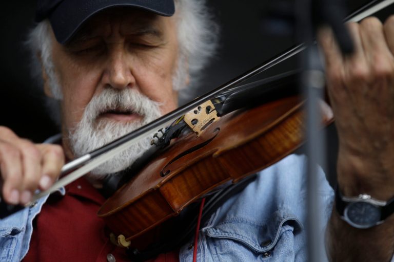 Michael Doucet performs with the zydeco band BeauSoleil at the New Orleans Jazz and Heritage Festival in New Orleans, Friday, May 3, 2013. (AP Photo/Gerald Herbert)