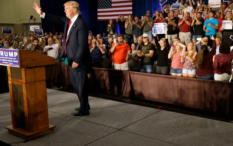 Republican presidential candidate Donald Trump greets supporters during a rally, Tuesday, in Dubuque, Iowa. (AP Photo/Charlie Neibergall)