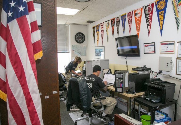 U.S. Department of Homeland Security Investigations computer forensic investigators check computers in Los Angeles on Wednesday, March 11, 2015. (AP Photo) Â 
