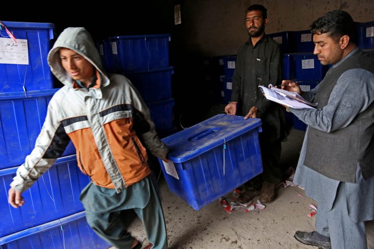 Afghan election workers carry a ballot box at an election commission office in Jalalabad east of Kabul, Afghanistan, Wednesday, April 2, 2014. Eight Afghan presidential candidates are campaigning for the third presidential election. Elections will take place on April 5, 2014. (AP Photo/Rahmat Gul)