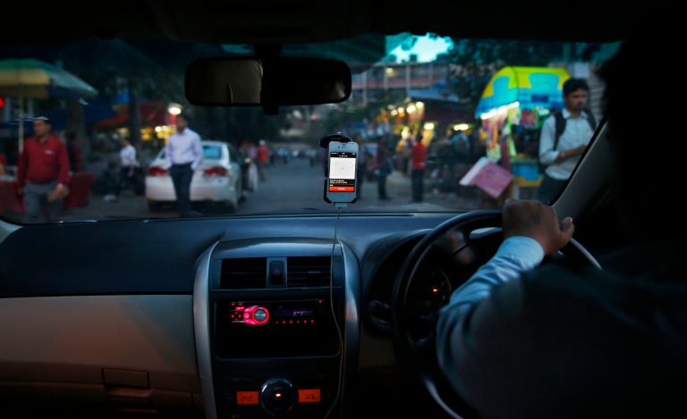 In this Wednesday, March 19, 2014 photo, an Uber taxi driver drives his car through a street in New Delhi, India. Riding on its startup success and flush with fresh capital, taxi-hailing smartphone app Uber is making a big push into Asia. The company has in the last year started operating in 18 cities in Asia and the South Pacific including Seoul, Shanghai, Bangkok, Hong Kong and five Indian cities. (AP Photo/Saurabh Das)