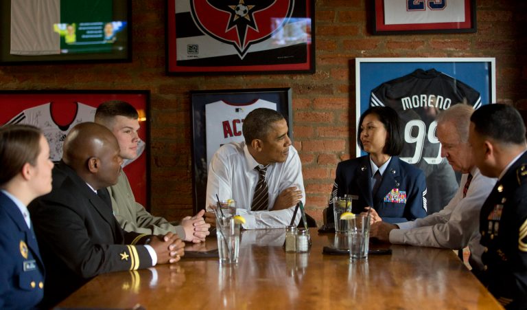 President Barack Obama and Vice President Joe Biden, second from right, meet with five active duty service members at Molly Malone's on Barracks Row in Washington, Tuesday, Nov. 12, 2013. (AP Photo/Pablo Martinez Monsivais)