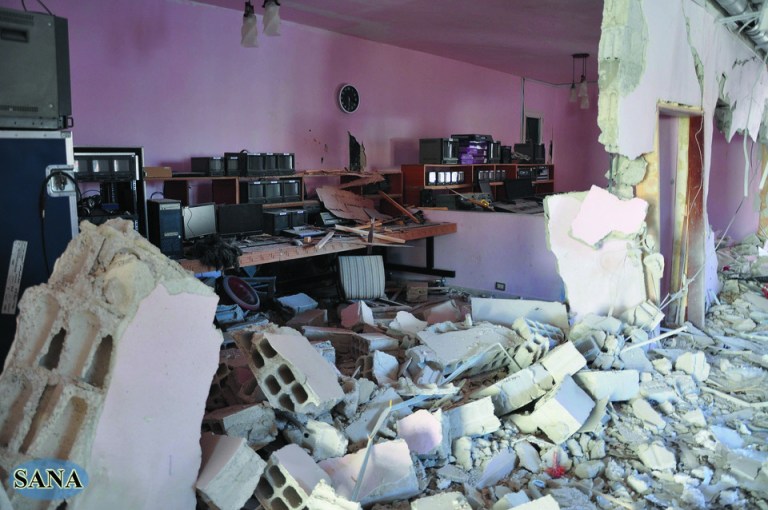 In this photo released by the Syrian official news agency, SANA, the damaged control room of Ikhbariya TV station is seen after it was attacked by gunmen in the town of Drousha, about 20 kilometers (14 miles) south of Damascus, Syria, Wednesday, June 27, 2012. Gunmen raided the headquarters of a pro-government Syrian TV station early Wednesday, demolishing the building and killing several employees, the state media reported. Syrian officials denounced what they called a rebel 