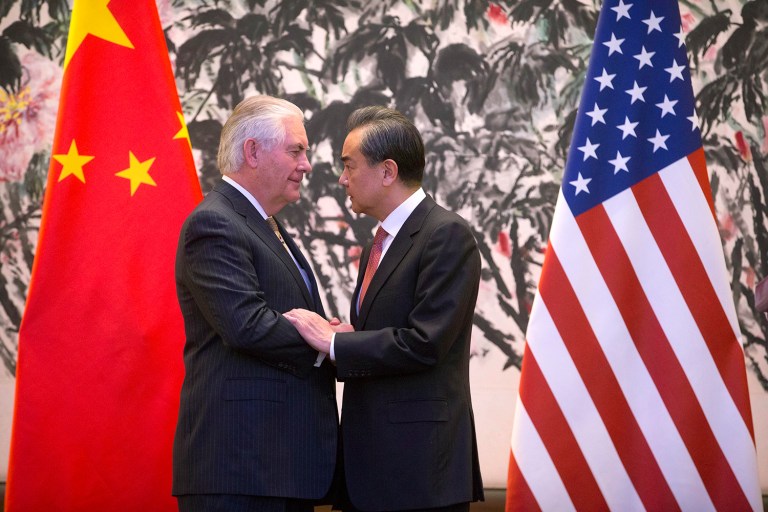 U.S. Secretary of State Rex Tillerson, left, and Chinese Foreign Minister Wang Yi stare at each other as they shake hands at the end of a joint press conference following their meeting at the Diaoyutai State Guesthouse in Beijing, China, on Saturday. Tillerson pushed for closer China-U.S. cooperation on dealing with North Korea's nuclear program in his first face-to-face talks Saturday with leading Chinese diplomats. (AP Photo/Mark Schiefelbein, Pool)