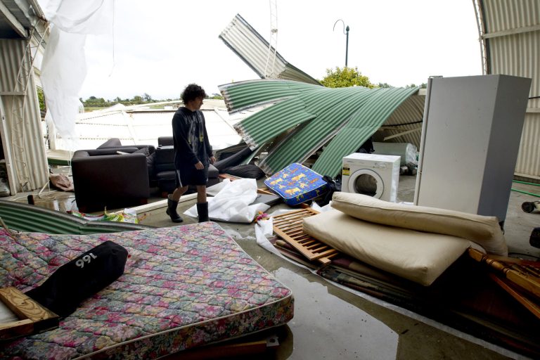   Cale Wood inspects his shed where debris was tossed around in Auckland, New Zealand, following a tornado Thursday, Dec. 6, 2012. A small tornado ripped through the city killing three people and forcing 250 more to evacuate damaged and powerless homes. (AP Photo/New Zealand Herald, Dean Purcell) AUSTRALIA OUT, NEW ZEALAND OUT  