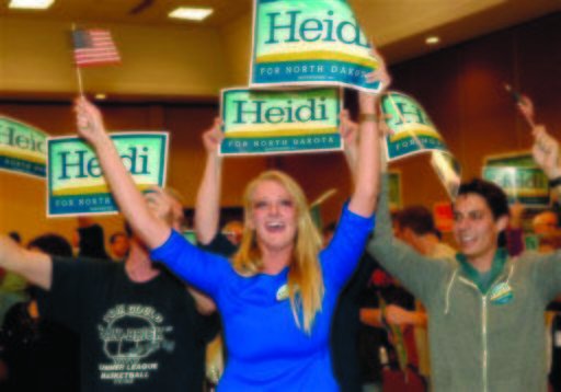 Supporters cheer for Heidi Heitkamp early Wednesday morning Nov. 7, 2012 in Bismarck, N.D.. Heitkamp is the Democratic candidate for North Dakota's U.S. Senate seat. At the time, Heitkamp was leading Republican challenger Rick Berg by several thousand votes. (AP Photo/Will Kincaid)