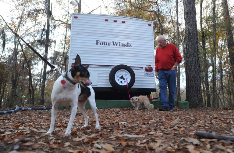   Frank Peetz stands near Sassy and Precious while camping at Lake Bistineau State Park Saturday Dec. 1, 2012 in Doyline, La. Authorities have begun moving 1 million pounds of improperly stored explosive powder to storage bunkers at the Camp Minden industrial site. State investigators found the explosives while inspecting property leased by Explo Systems, where an above-ground storage magazine exploded in October. (AP Photo/The Shreveport Times, Jim Hudelson) MAGS OUT; MANDATORY CREDIT SHREVEPORTTIMES.COM; NO SALES  