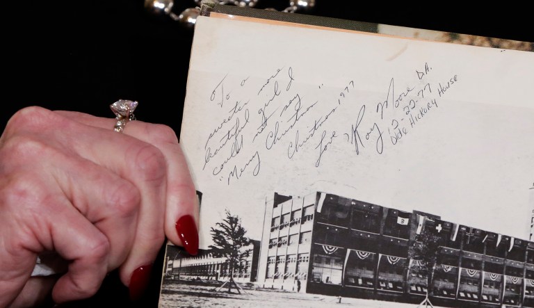 Beverly Young Nelson, the latest accuser of Alabama Republican Roy Moore, showed her high school yearbook signed by Moore, at a news conference Monday. Nelson says Moore assaulted her when she was 16. (AP Photo/Richard Drew)