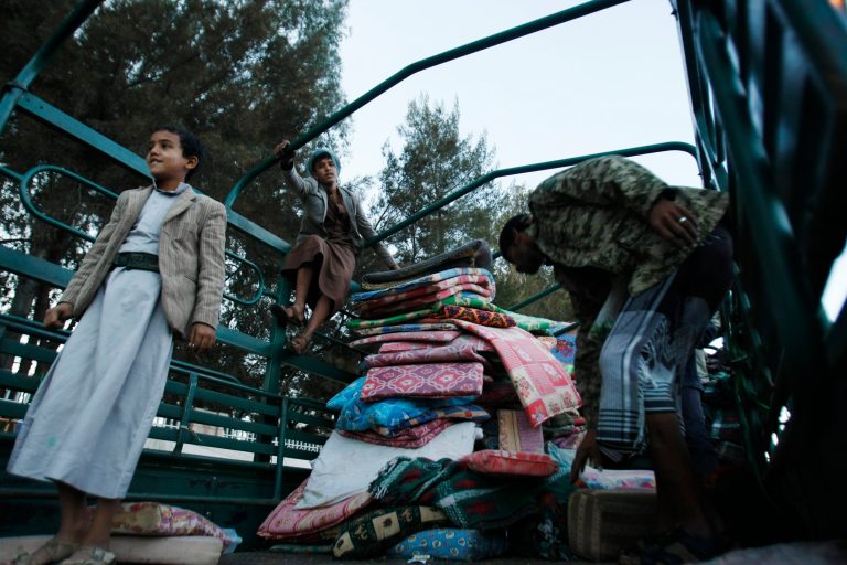 Houthi Shiite rebels collect blankets ahead of remove tents erected two months ago, at a sit-in in a main road leading to the airport in Sanaa, Yemen, Thursday, Oct. 16, 2014. (AP Photo/Hani Mohammed)