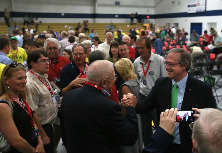 People congratulate David Young, right, after he received the Republican nomination in Iowa's 3rd Congressional District for the U.S. House during a special convention June 21 in Urbandale, Iowa. (AP Photo/The Des Moines Register, Mary Willie)