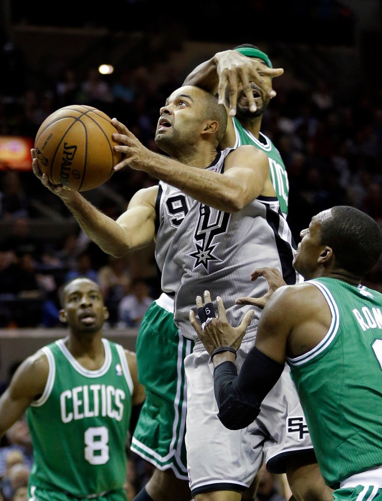   San Antonio Spurs' Tony Parker (9), of France, drives between Boston Celtics' Chris Wilcox, center, Jeff Green (8) and Rajon Rondo, right, during the second quarter of an NBA basketball game, Saturday, Dec. 15, 2012, in San Antonio. (AP Photo/Eric Gay)  