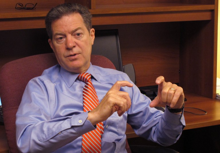 Republican Gov. Sam Brownback says he'll work to create 100,000 new private-sector jobs over four years if he's re-elected. (AP Photo/Credit withheld)