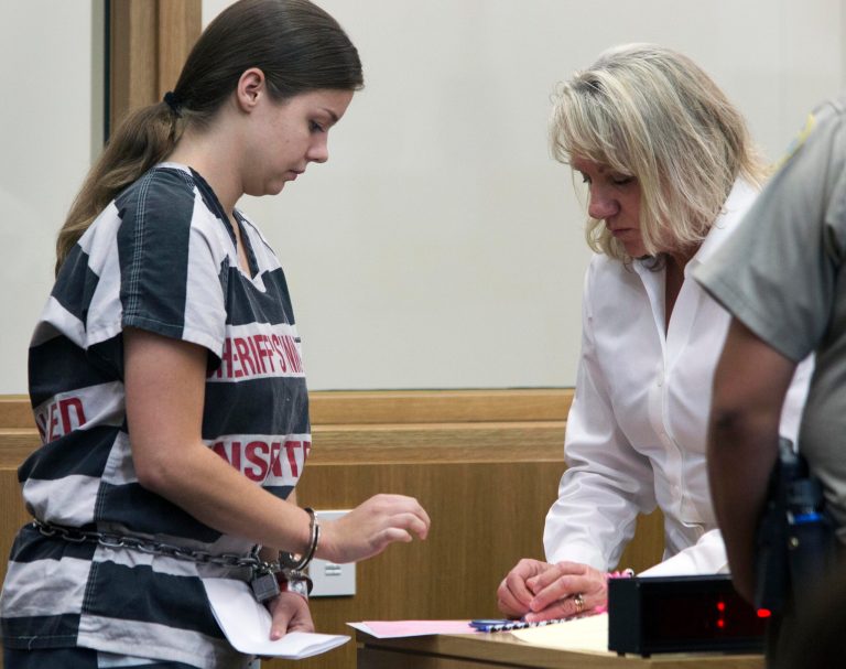   Elizabeth Johnson completes paperwork after being sentenced Friday, Dec. 7, 2012 in Phoenix. Johnson, an Arizona woman who was convicted in her young son's disappearance nearly three years ago was sentenced Friday to 5 1/4 years in prison after tearfully telling the judge she thought she deserved the maximum of 9 1/2 years. (AP Photo/The Arizona Republic, Mark Henle) MARICOPA COUNTY OUT; MAGS OUT; NO SALES  