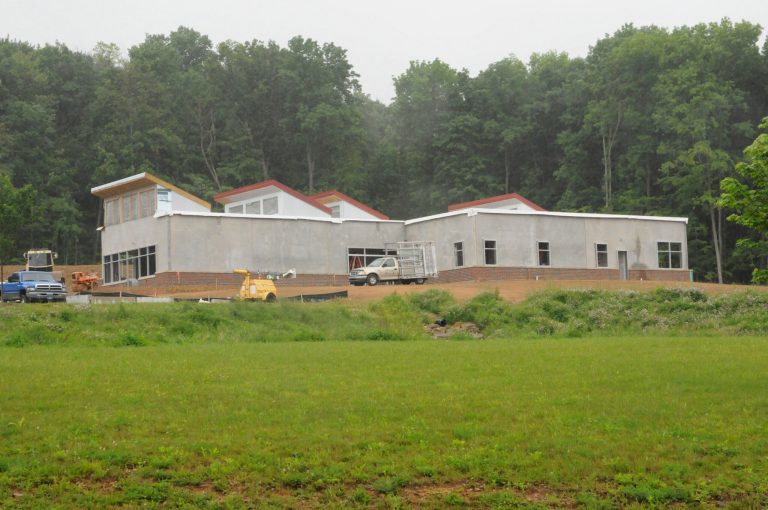   In this June 5, 2012 photo, construction continues on the Sustainable Energy Research Facility (SERF), a completely off-grid green building, at Frostburg State University in Frostburg, Md. The building will generate its own electricity from solar and wind power. SERF construction will be completed this summer and equipment for the structure will be installed in the fall, at which point the building will be functional. (AP Photo/Cumberland Times-News/Steven Bittner)  