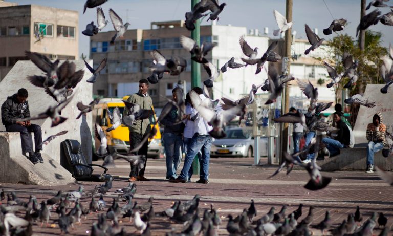 FILE - In this Jan. 10, 2012 file photo, migrant workers from Africa gather at an outdoor square in Tel Aviv. Israel has reached an agreement to send thousands of African migrants to an unidentified country, a court document obtained Monday revealed, a plan that has elicited criticism over its potential harm to migrants' rights. (AP Photo/Dan Balilty, File)